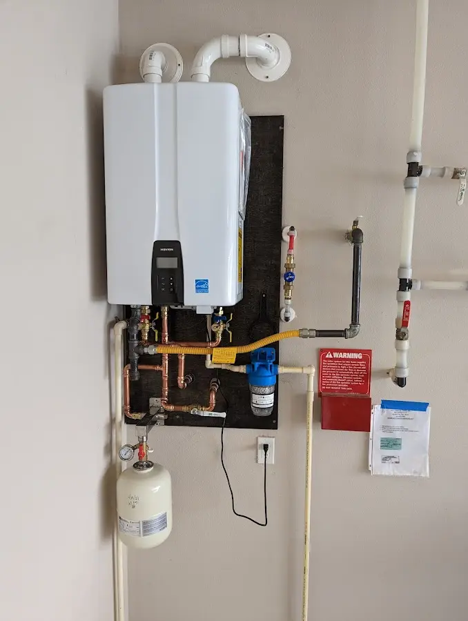 Professional plumber installing copper piping in a Inverness home